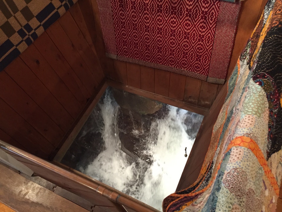 Viewing window of rushing water from inside a craft store