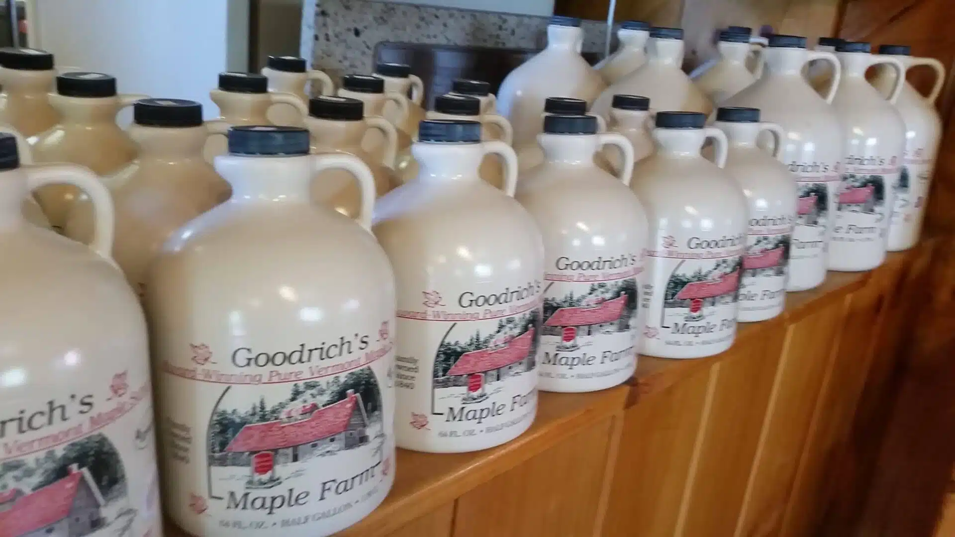 gallon jugs of Vermont maple syrup in a shelf