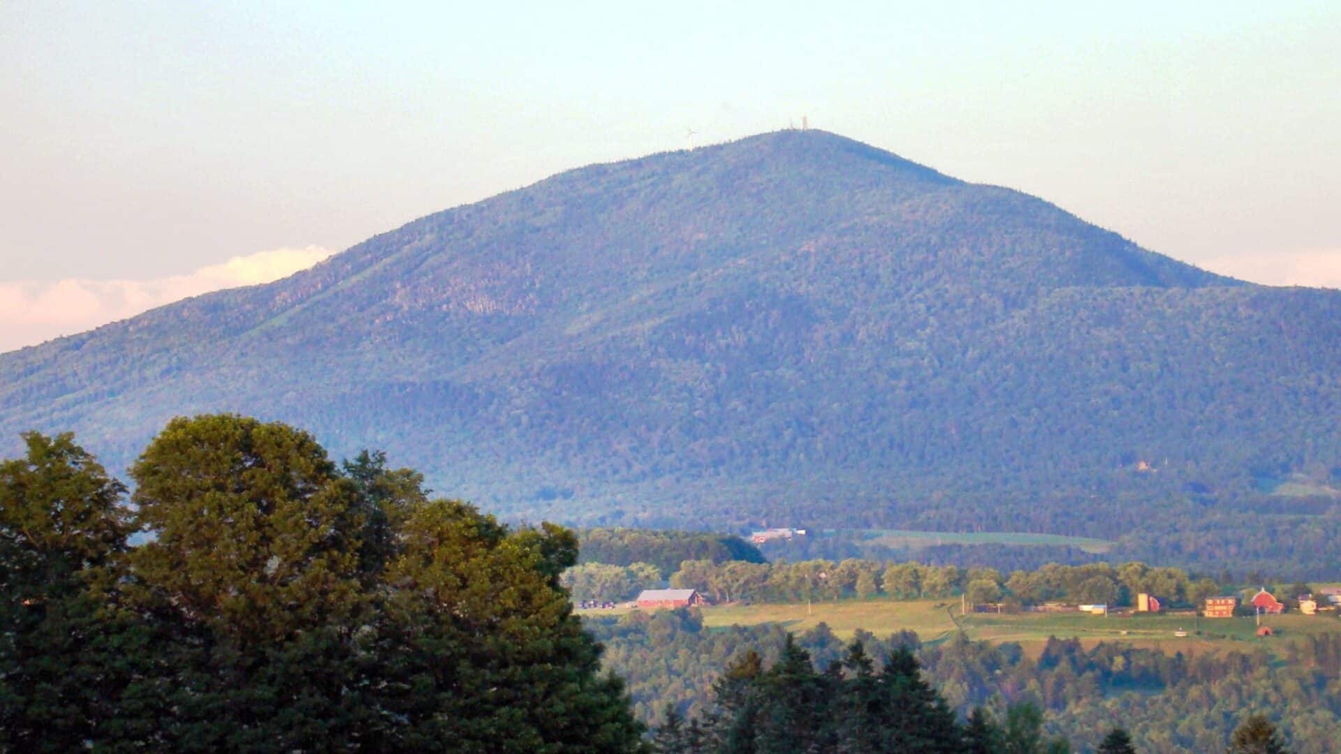 Burke Mountain Vermont|3 people on horseback riding through the hills