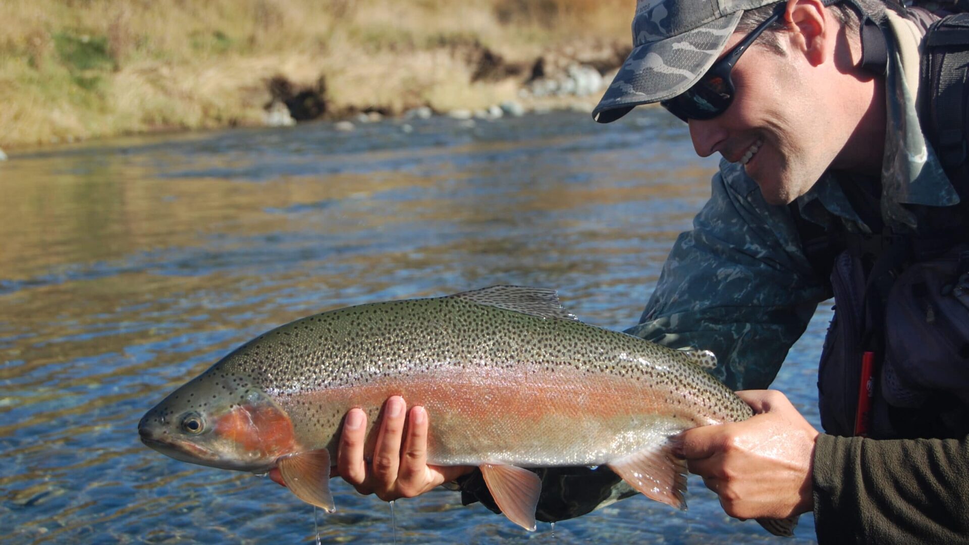 man holding a brook trout