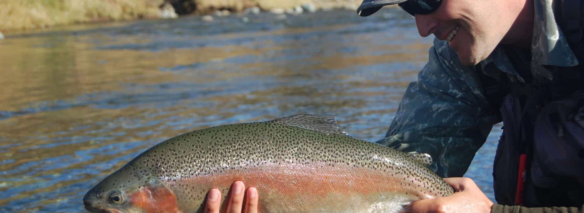 man holding a brook trout