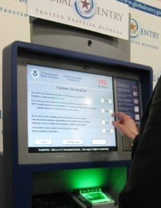 person using touchscreen terminal at airport