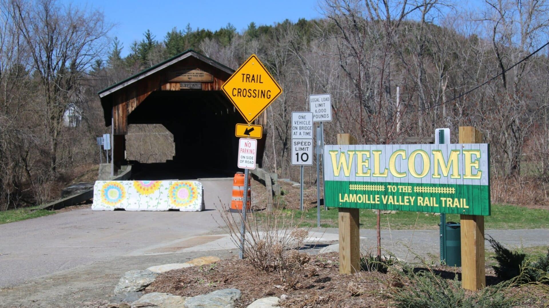 signs at the Vermont Lamoille Rail Trail bike path St. Johnsbury to Danville|man on a bike in the woods|Map Lamoille Rail Trail St johnsbury to Danville Vermont|signs at the Vermont Lamoille Rail Trail St. Johnsbury to Danville