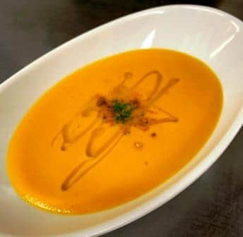 a white bowl filled with sweet potato soup