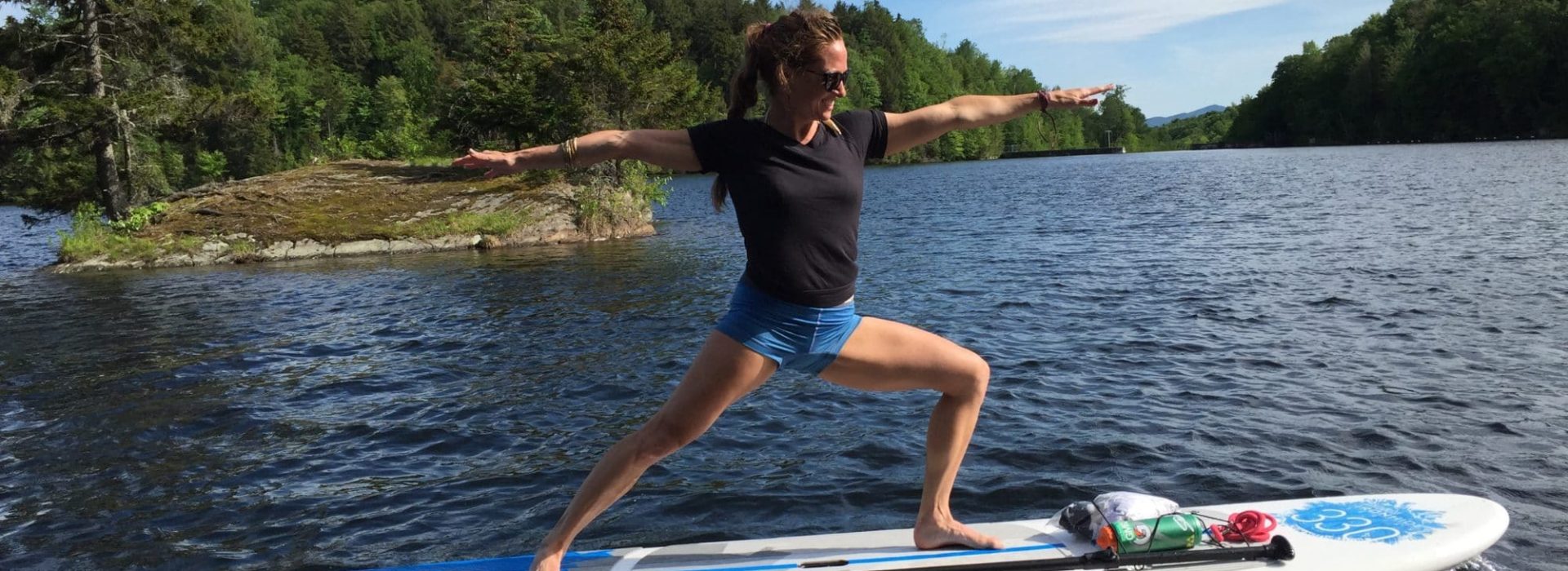 woman standing on a paddle board on the the water