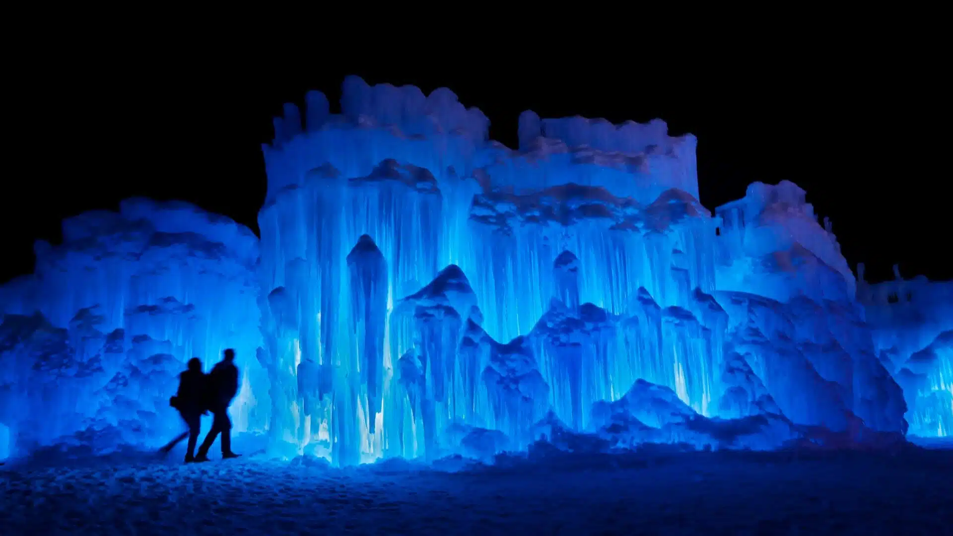 couple standing in front of the Ice castles