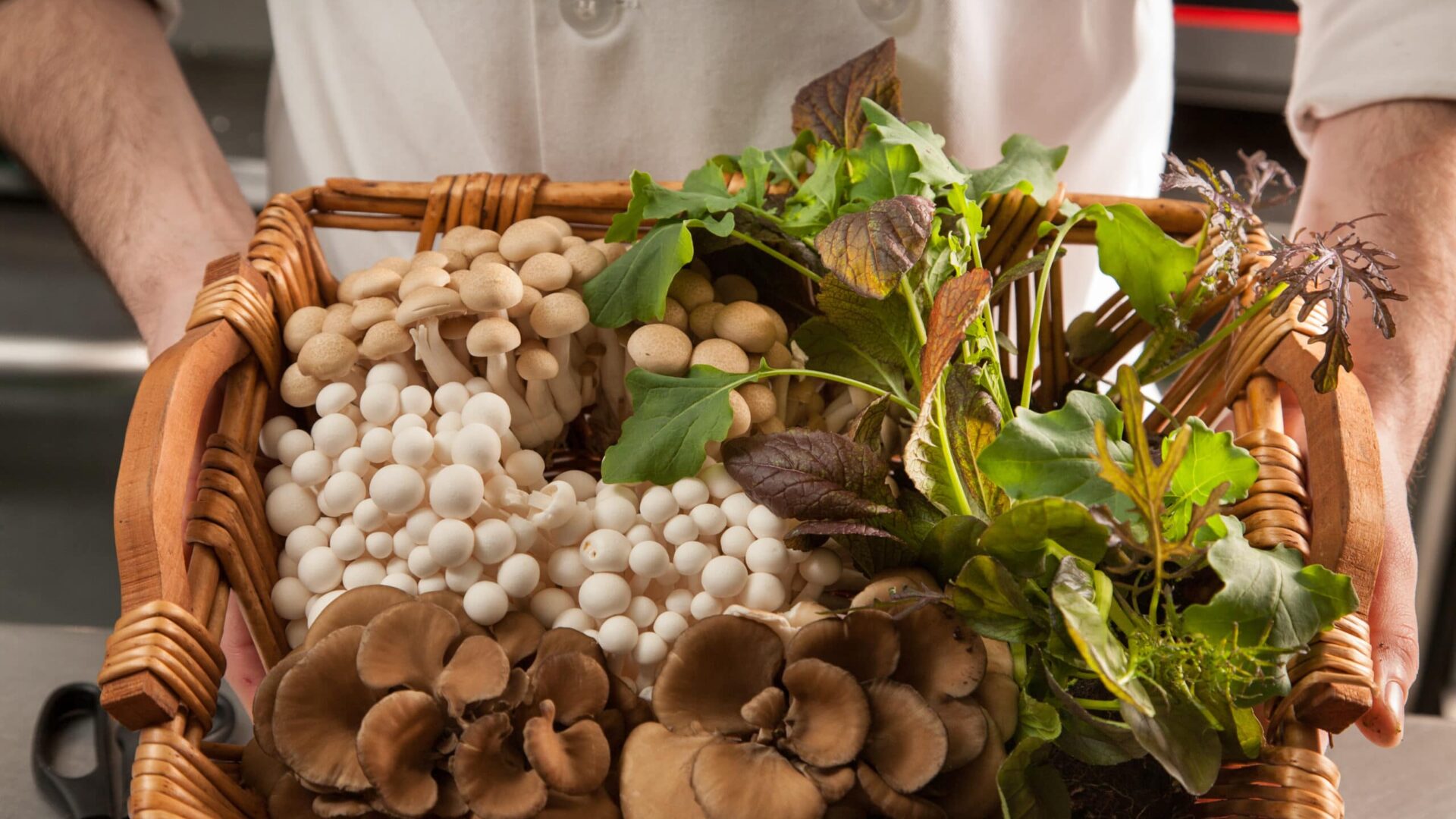 a wicker basket full of fresh mushrooms