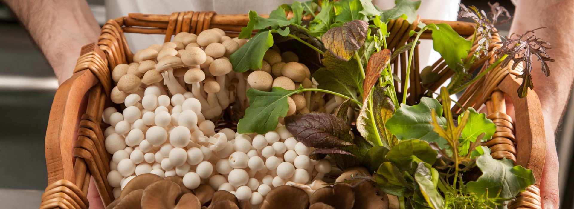 a wicker basket full of fresh mushrooms