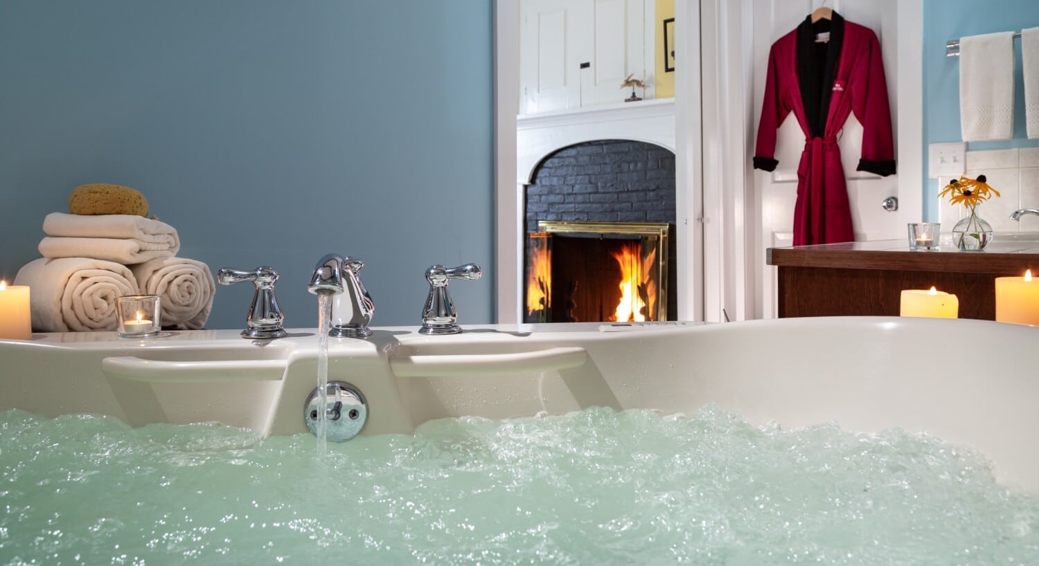 bubbly spa tub with view of fireplace