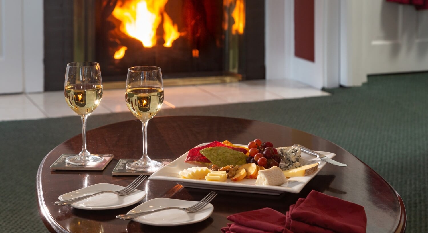 wine and cheese in front of glowing fireplace