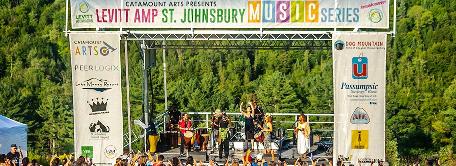 outside concert with band on stage and audience clapping|Levitt AMP ST. Johnsbury Vermont Music Concert Series Free at Dog Mountain|Levitt AMP St. Johnsbury Vermont Music Series Free Outdoor concerts at Dog Mountain|Sarah Shook & The Disarmers singing at the Dog Mountain Free music concert series|musical group dancing in the street