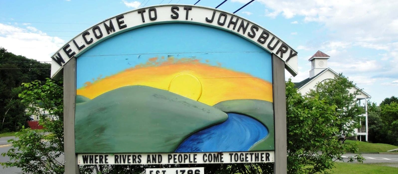 welcome sign in St. Johnsbury Vermont|man standing on the Three Rivers Bike path St. Johnsbury VT near Rabbit Hill Inn|welcome sign in St. Johnsbury Vermont|welcome sign at St. Johnsbury Vermont