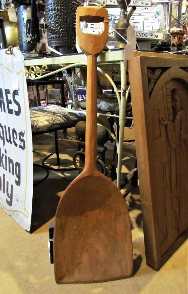 Old wooden shovel on display at an antique store