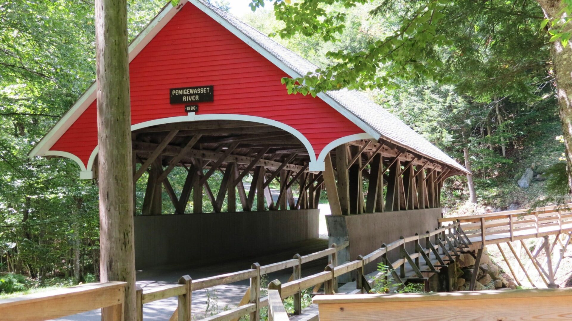 red Covered bridge in New Hampshire|girl on covered bridge