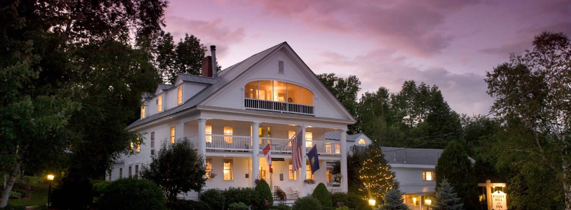 rabbit Hill inn at dusk under a purple sky|woman on cover of travel magazine