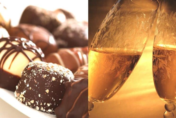 Close up view of chocolate truffles and champagne glasses